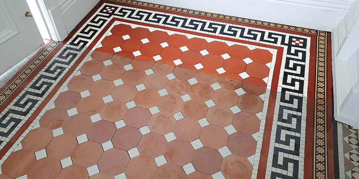 An expert in the process of carefully restoring a damaged Victorian tiled floor to its former glory