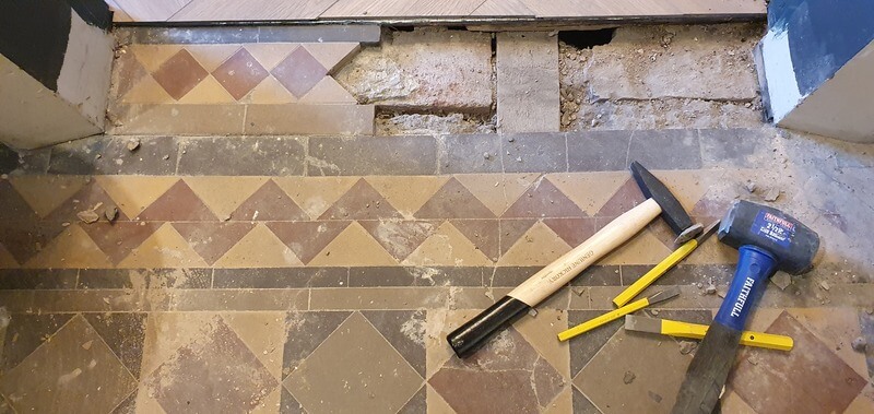 Damaged Victorian floor tiles in Sarah and John's home